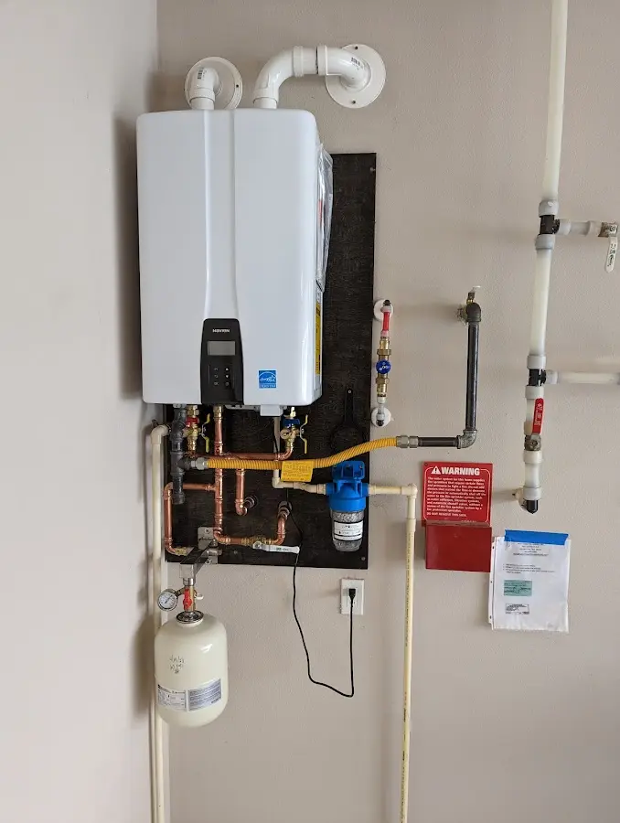 Professional plumber installing copper piping in a Cortland home